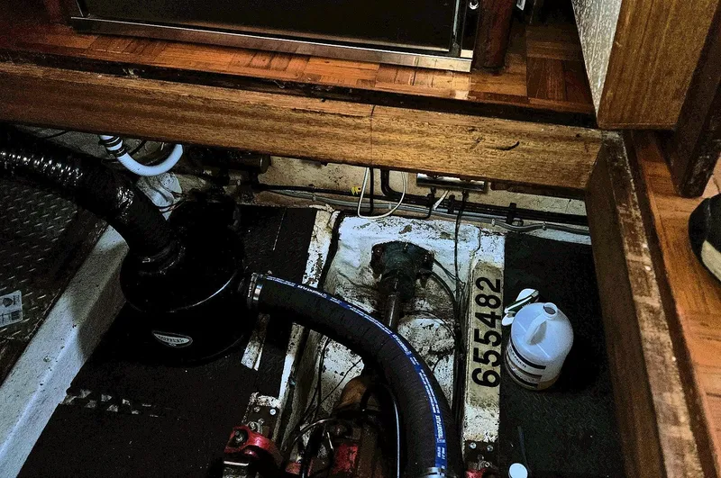 Slide: The Image of Engine room of 1981 Ocean Double Cabin Trawler with visible pipes and equipment. - 16