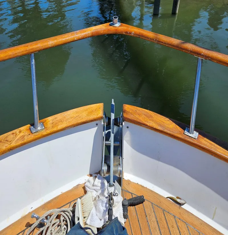 Slide: The Image of Bow of 1981 Ocean Double Cabin Trawler with wooden railings and anchor equipment. - 18