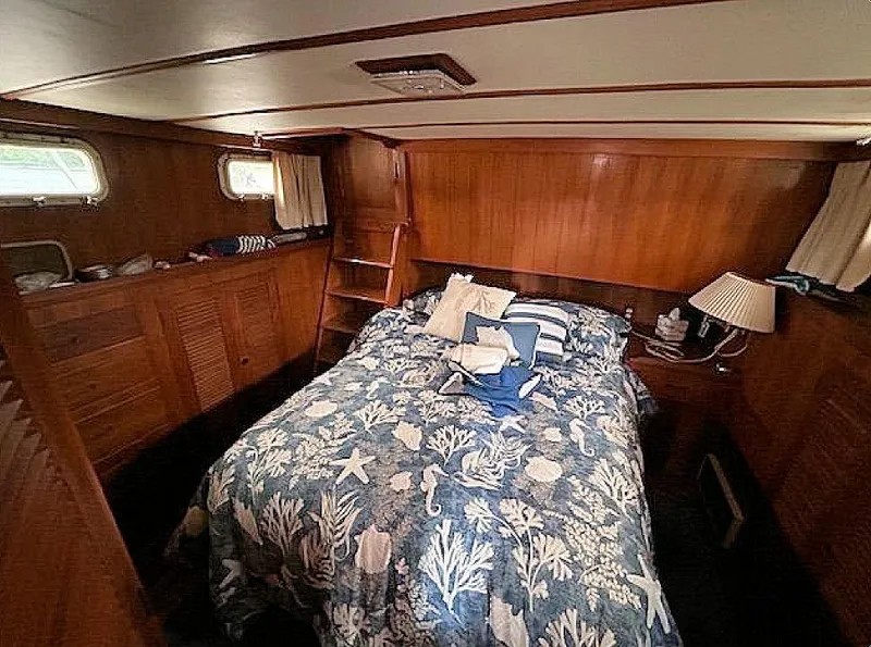 Slide: The Image of Cozy cabin interior of 1981 Ocean Double Cabin Trawler with nautical-themed bedding. - 4