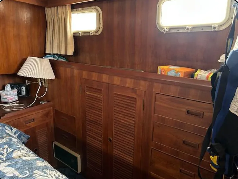 Slide: The Image of Wood-paneled cabin interior of 1981 Ocean Double Cabin Trawler with storage and porthole windows. - 5