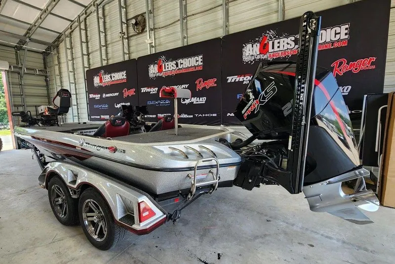 Slide: The Image of 2021 Ranger Z521C Ranger Cup Equipped boat in a garage, featuring a powerful engine. - 8