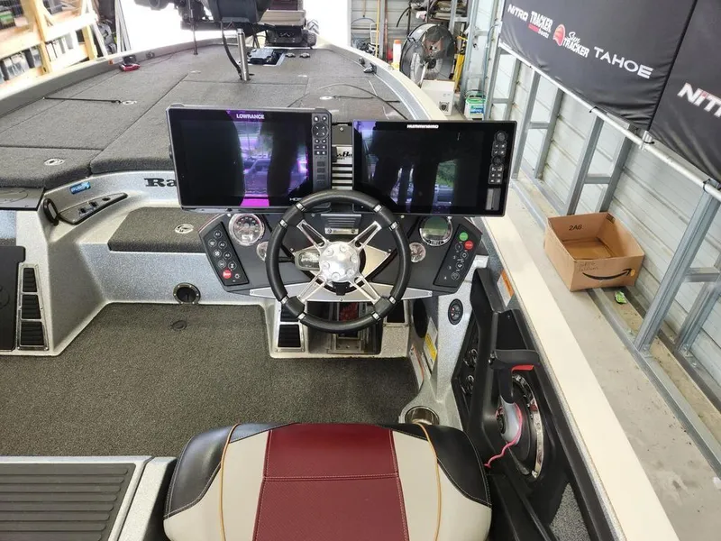 Slide: The Image of 2021 Ranger Z521C boat cockpit with advanced navigation screens and steering wheel. - 9