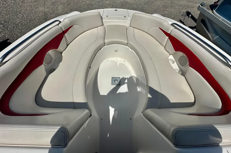 Slide: The Image of 2003 Chaparral 223 Sunesta boat interior with white and red seating, viewed from above. - 10