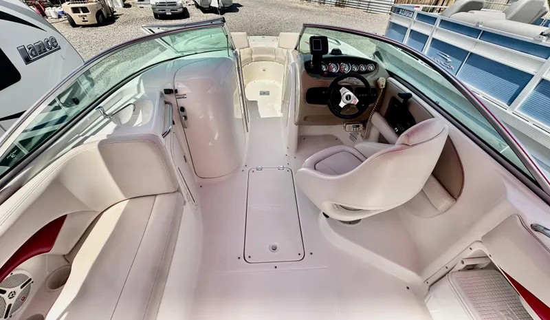 Slide: The Image of 2003 Chaparral 223 Sunesta boat interior with steering wheel and seating. - 6