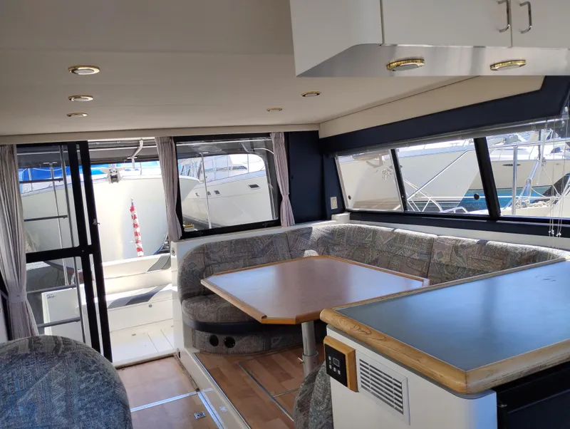 Slide: The Image of Interior of 1992 Bayliner 4388 Motoryacht with dining area and large windows. - 10