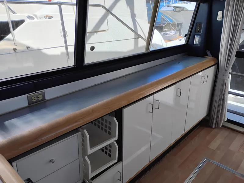 Slide: The Image of Interior of 1992 Bayliner 4388 Motoryacht with cabinets and large windows. - 12