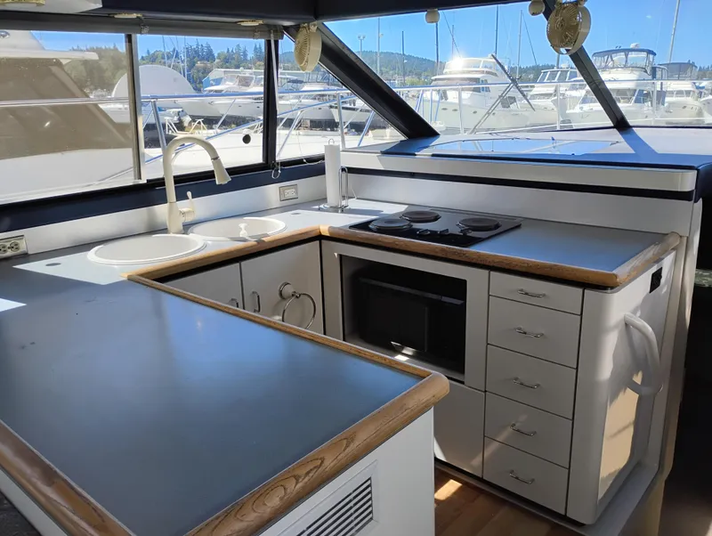 Slide: The Image of Interior of 1992 Bayliner 4388 Motoryacht kitchen with stove, sink, and microwave. - 16