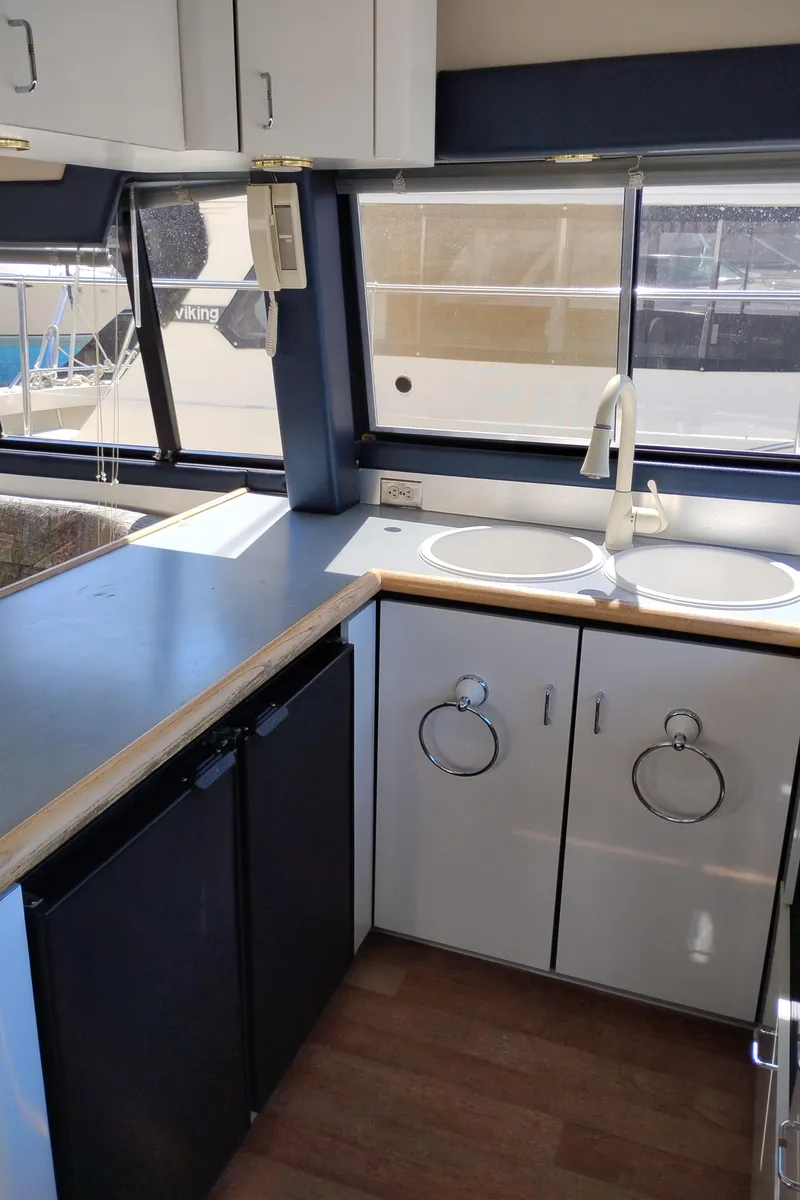 Slide: The Image of 1992 Bayliner 4388 Motoryacht kitchen with dual sinks and modern cabinetry. - 18