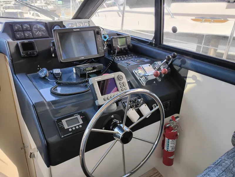 Slide: The Image of 1992 Bayliner 4388 Motoryacht helm with navigation equipment and steering wheel. - 22