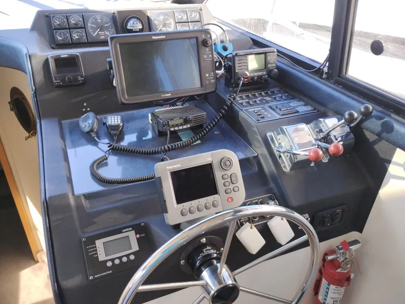 Slide: The Image of 1992 Bayliner 4388 Motoryacht helm with navigation equipment and controls. - 23
