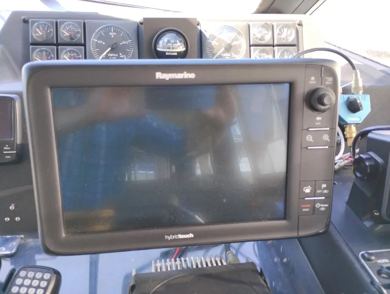 Slide: The Image of Raymarine navigation system on 1992 Bayliner 4388 Motoryacht dashboard with gauges. - 24