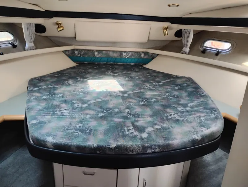 Slide: The Image of 1992 Bayliner 4388 Motoryacht interior cabin with patterned bed and porthole windows. - 29