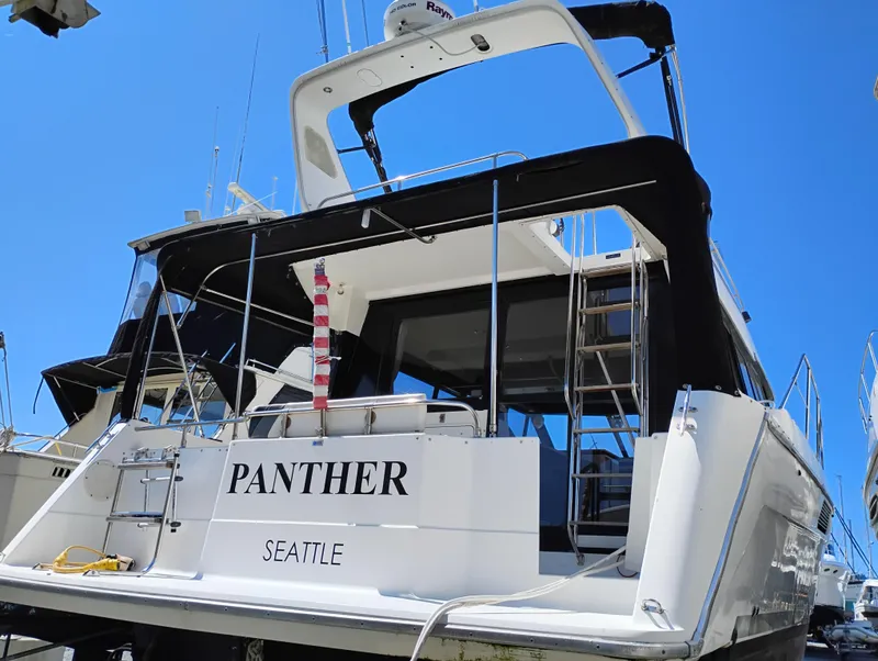 Slide: The Image of 1992 Bayliner 4388 Motoryacht docked, rear view with "Panther" and "Seattle" text. - 3