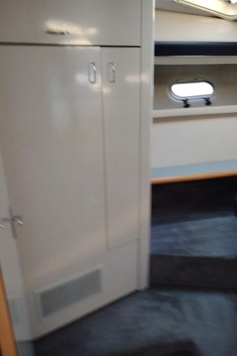 Slide: The Image of Interior of 1992 Bayliner 4388 Motoryacht with storage and porthole window. - 31