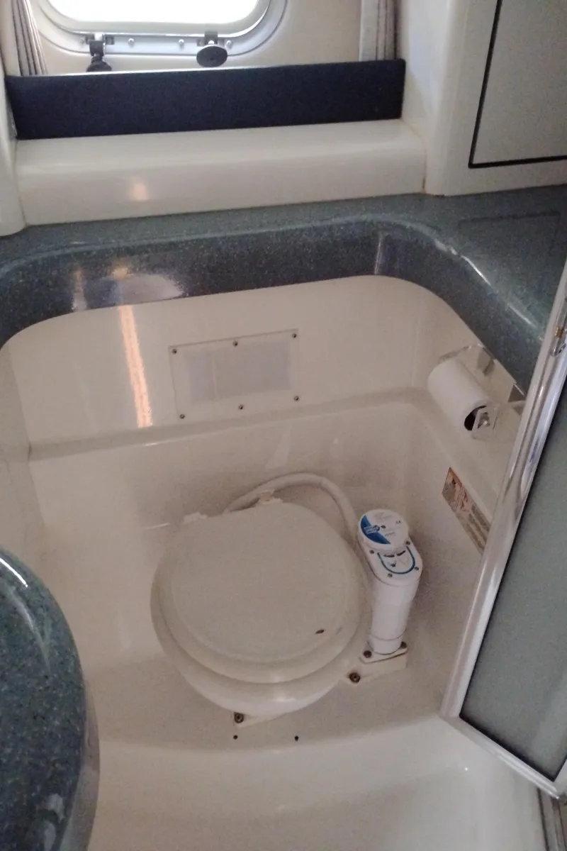 Slide: The Image of Bathroom interior of 1992 Bayliner 4388 Motoryacht with compact toilet and window. - 32