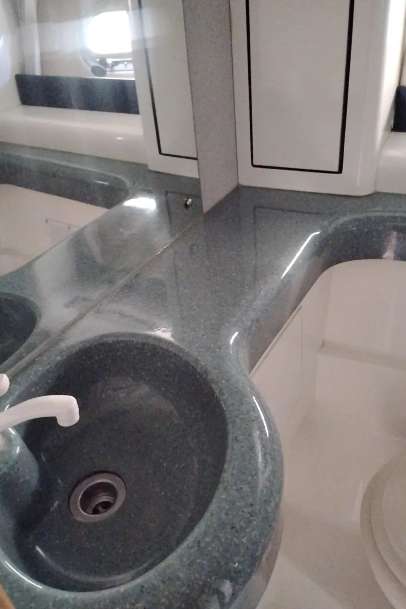 Slide: The Image of Bathroom sink area in a 1992 Bayliner 4388 Motoryacht, featuring a sleek countertop design. - 33