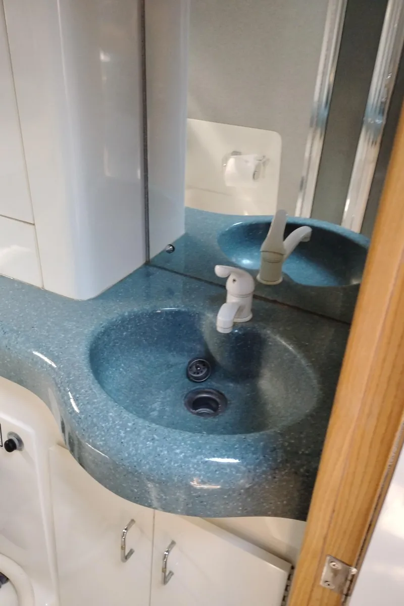 Slide: The Image of Bathroom sink in 1992 Bayliner 4388 Motoryacht with blue countertop and white fixtures. - 34
