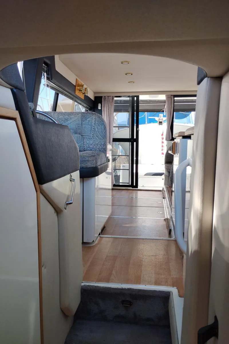 Slide: The Image of Interior view of 1992 Bayliner 4388 Motoryacht, featuring seating and wooden flooring. - 36