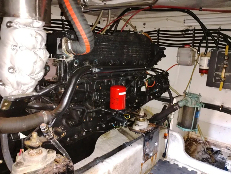 Slide: The Image of Engine room of a 1992 Bayliner 4388 Motoryacht, showcasing mechanical components and wiring. - 38