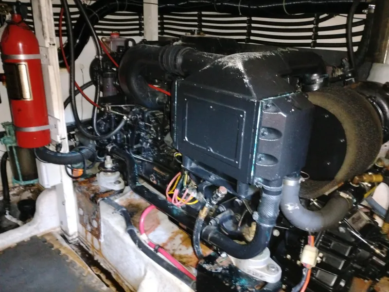 Slide: The Image of Engine room of a 1992 Bayliner 4388 Motoryacht with visible fire extinguisher. - 39