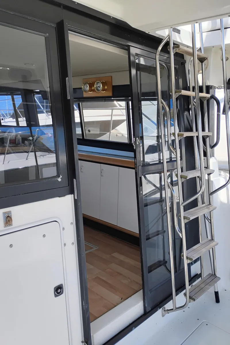 Slide: The Image of 1992 Bayliner 4388 Motoryacht interior with ladder and glass door, showcasing modern design. - 4