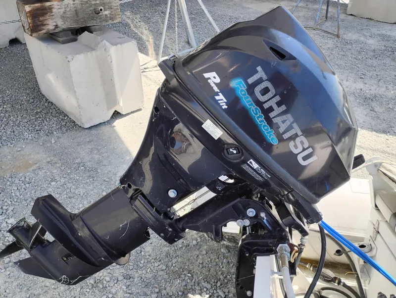 Slide: The Image of Tohatsu FourStroke outboard motor on gravel, near Bayliner 4388 Motoryacht, 1992 model. - 42