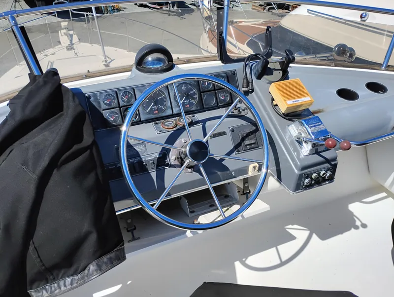 Slide: The Image of 1992 Bayliner 4388 Motoryacht helm with steering wheel and control panel. - 7