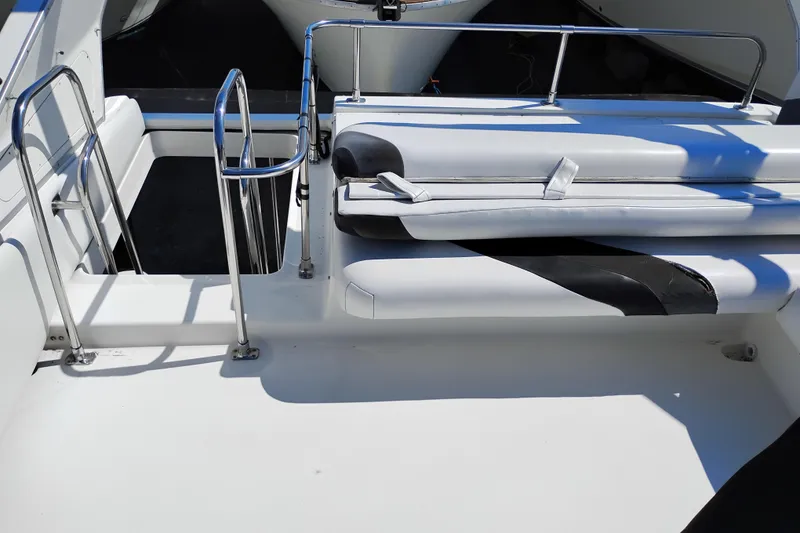 Slide: The Image of 1992 Bayliner 4388 Motoryacht deck with white seating and stainless steel railings. - 8