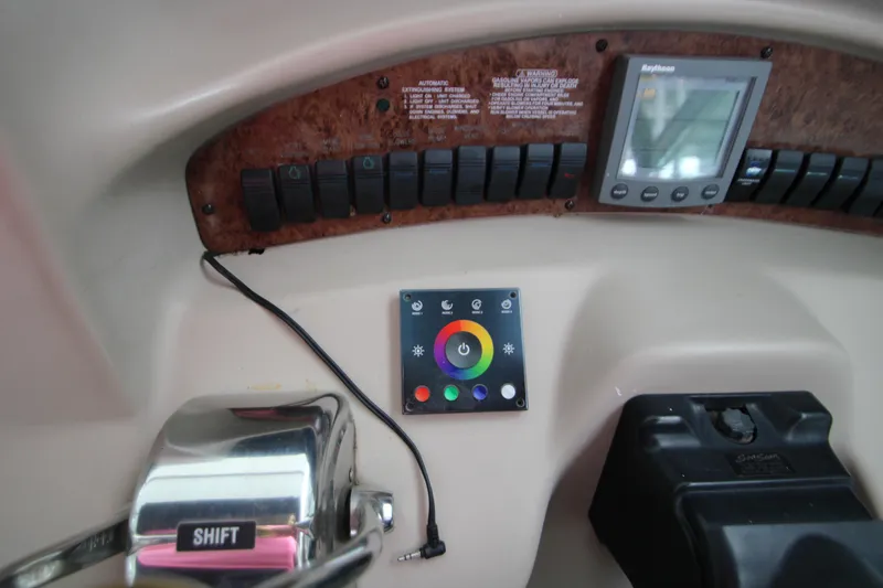 Slide: The Image of Sea Ray 340 Sundancer 2001 helm with switches and display. - 12