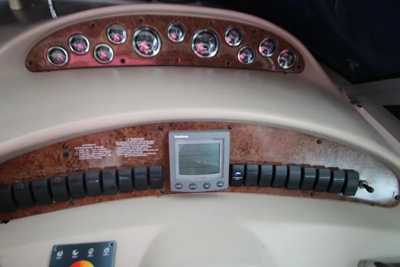 Slide: The Image of 2001 Sea Ray 340 Sundancer dashboard with instruments and switches. - 13