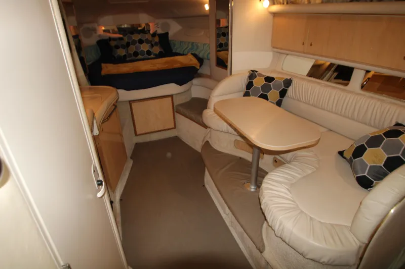 Slide: The Image of Interior of a 2001 Sea Ray 340 Sundancer yacht with cozy seating area. - 23