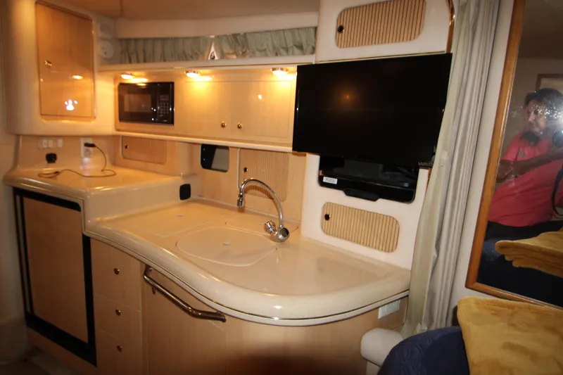 Slide: The Image of Interior of 2001 Sea Ray 340 Sundancer with kitchen and TV. - 35