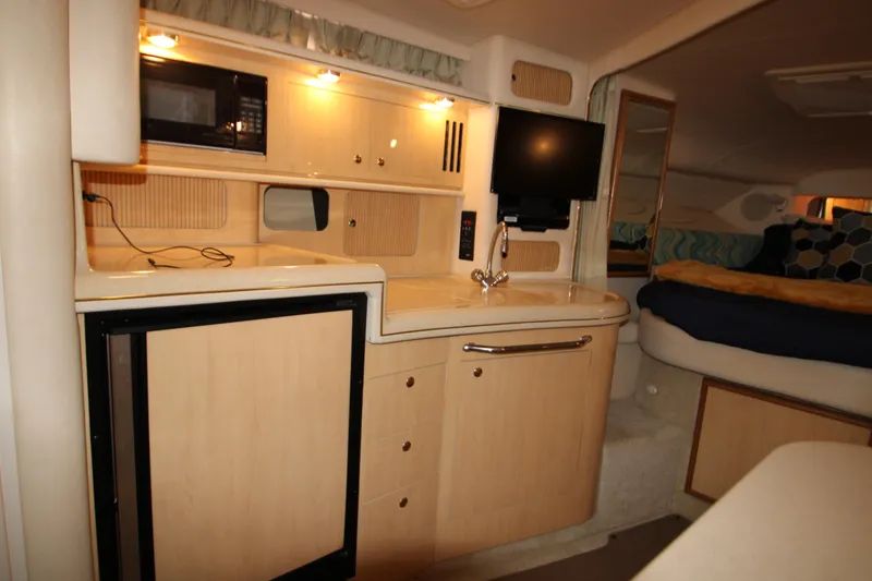 Slide: The Image of Interior of 2001 Sea Ray 340 Sundancer with kitchenette and sleeping area. - 42