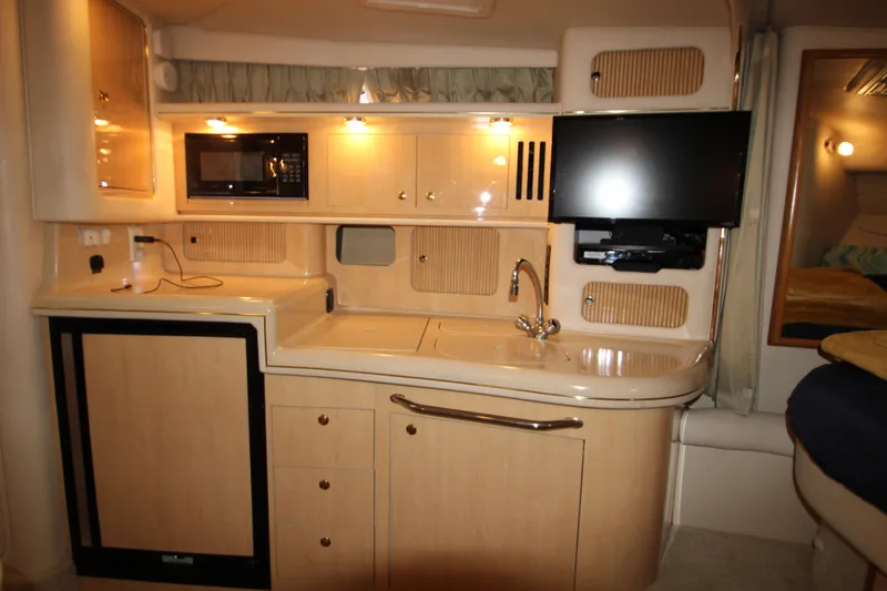 Slide: The Image of Interior of 2001 Sea Ray 340 Sundancer with kitchenette and TV. - 45
