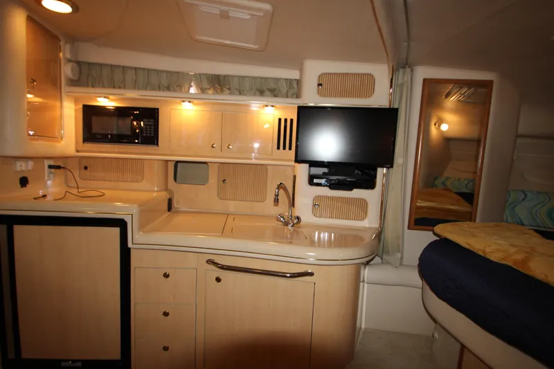 Slide: The Image of Interior of 2001 Sea Ray 340 Sundancer with kitchen and TV. - 46