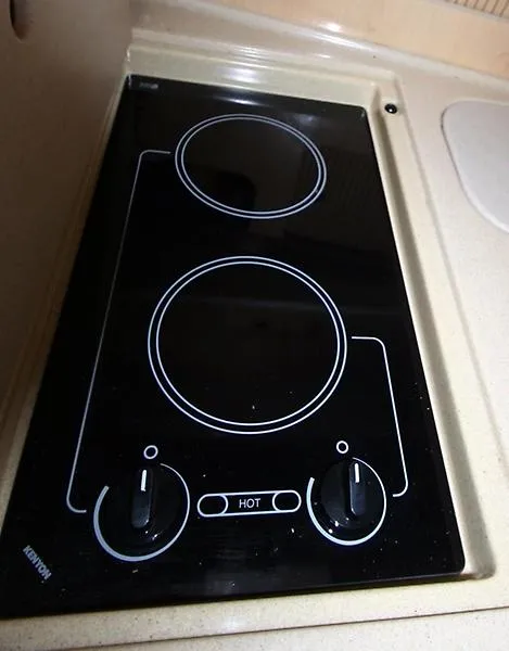 Slide: The Image of Stovetop on 2001 Sea Ray 340 Sundancer yacht, featuring dual burners and control knobs. - 22