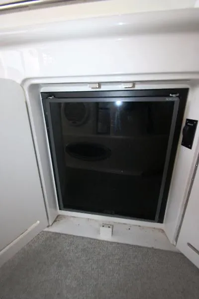 Slide: The Image of 2001 Sea Ray 340 Sundancer cabin refrigerator with black door. - 35