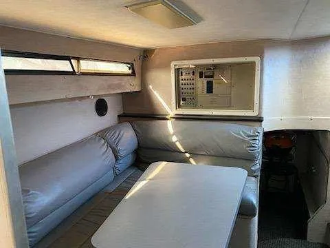 Slide: The Image of 1988 Trojan International boat interior with seating area and control panel. - 10