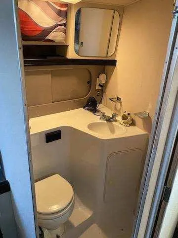 Slide: The Image of 1988 Trojan International boat bathroom with sink, toilet, and mirror. - 12