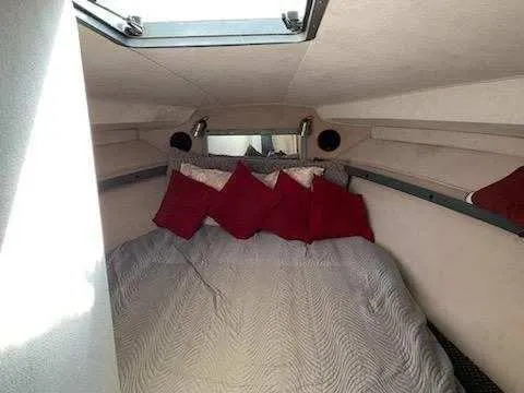 Slide: The Image of Cozy cabin interior of 1988 Trojan International boat with skylight and red pillows. - 13