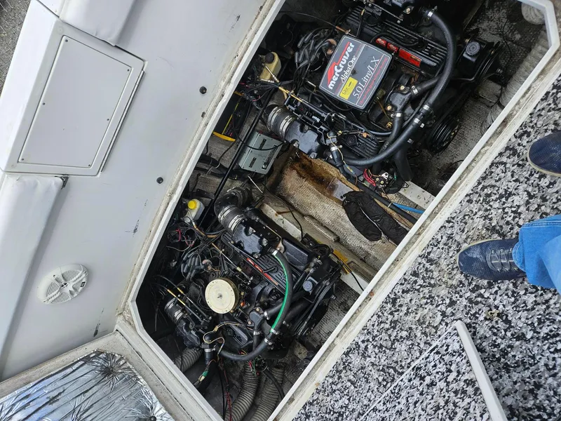 Slide: The Image of Engine compartment of a 1988 Trojan International boat, featuring a MerCruiser engine. - 16