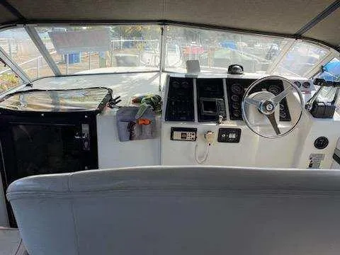 Slide: The Image of 1988 Trojan International boat cockpit with steering wheel and control panel. - 5