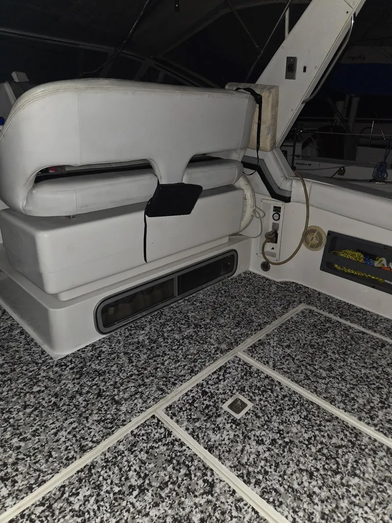 Slide: The Image of 1988 Trojan International boat interior with white seating and speckled flooring. - 7