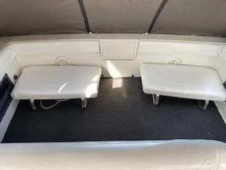 Slide: The Image of 1988 Trojan International boat interior with cushioned seating and carpeted floor. - 9