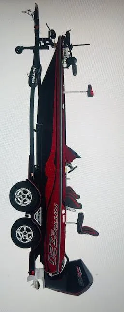 Slide: The Image of 2026 Nitro Z21 XL Pro boat on trailer, side view, red and black design. - 2