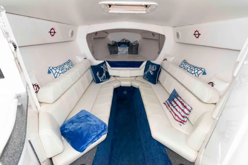 Slide: The Image of Luxurious interior of 1999 Fountain 47 Lightning boat with white seating and nautical-themed decor. - 21