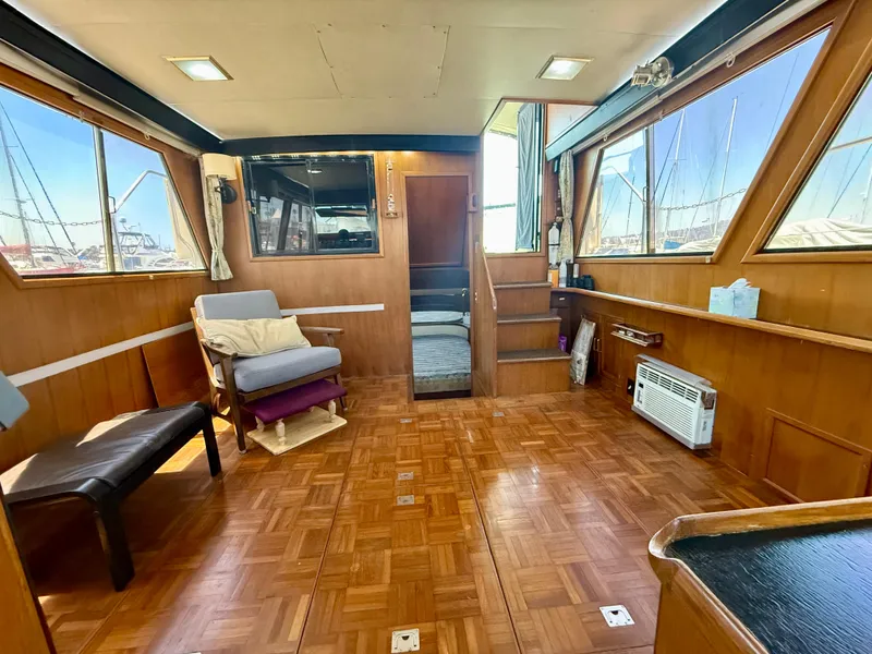 Slide: The Image of Interior of 1986 Kha Shing Nautique yacht with wood paneling and seating. - 14