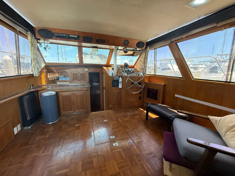 Slide: The Image of Interior of 1986 Kha Shing Nautique yacht with wooden decor and helm station. - 15