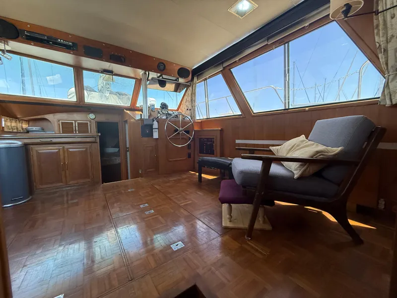 Slide: The Image of Interior of 1986 Kha Shing Nautique yacht with wooden decor and large windows. - 18