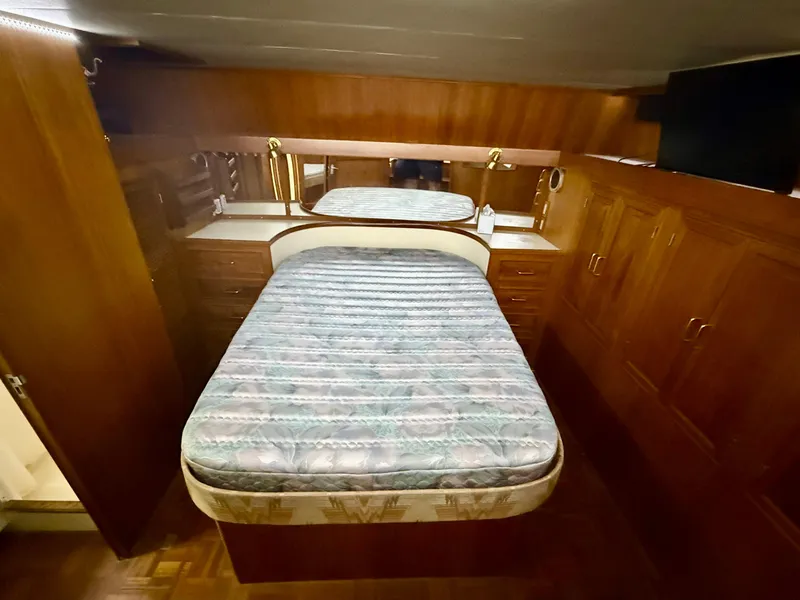 Slide: The Image of 1986 Kha Shing Nautique yacht bedroom with wooden cabinetry and a central bed. - 20